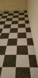 A completed checkered carpet tile installation in a room by Point Place Flooring in Toledo, OH.