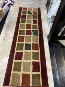 Long checkered runner rug on a tiled floor, cleaned by PROlific Cleaning Services LLC in Indianapolis, IN.