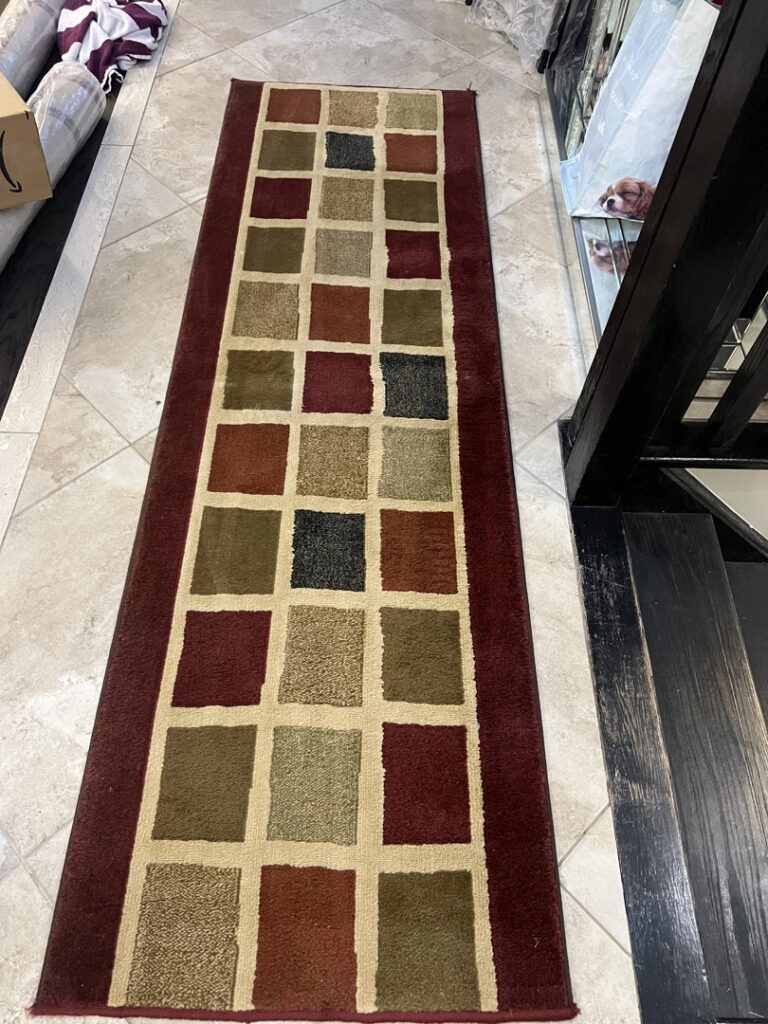 Long checkered runner rug on a tiled floor, cleaned by PROlific Cleaning Services LLC in Indianapolis, IN.