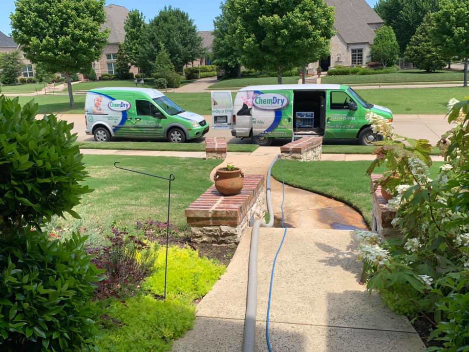 Two Precision Chem-Dry Of DFW service vans parked in a residential driveway, ready for a carpet cleaning job in North Richland Hills, TX.