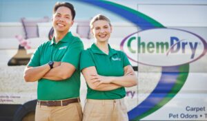 Two smiling Chem-Dry team members standing in front of a branded van for Mountainview Chem-Dry in Birmingham, AL.