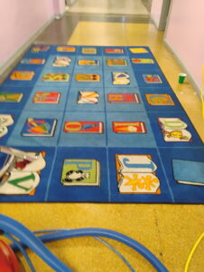 A children's alphabet rug after professional cleaning with equipment visible by Ready2go Professional Carpet & Upholstery Cleaning in Boston, MA