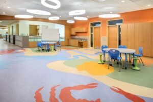 A colorful children's play area featuring durable, patterned resilient flooring installed by Capital Carpet & Flooring Specialists in Wilmington, MA