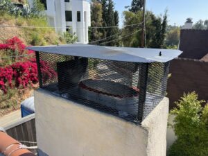An overhead view of a chimney with a new metal mesh cap installed by Fireplace Freddie in Shadow Hills, CA.