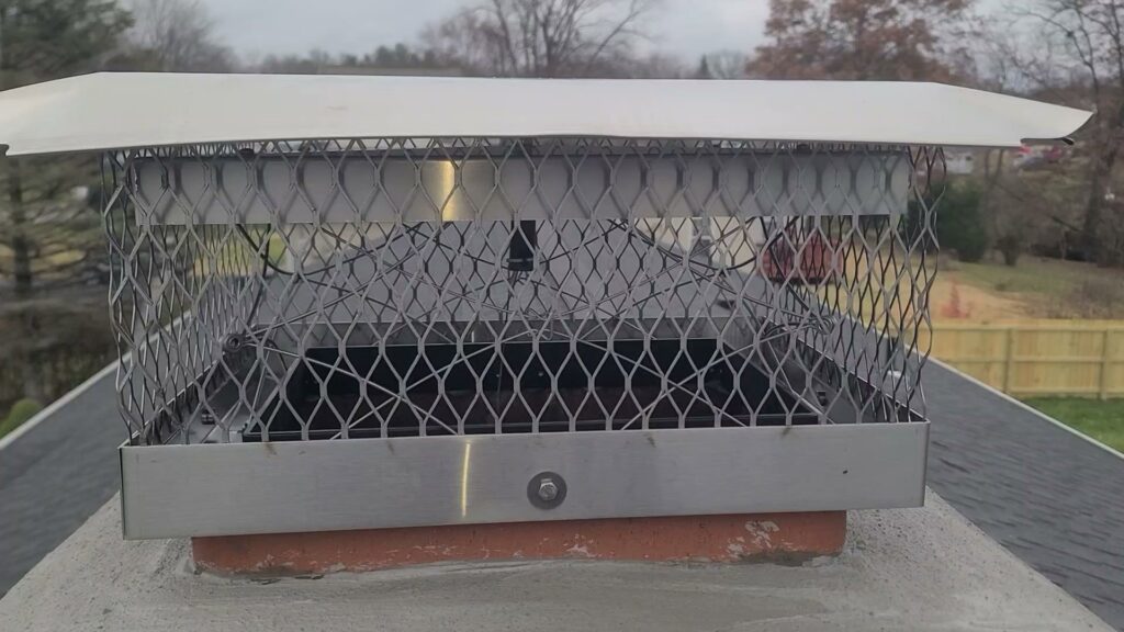 A well-maintained chimney cap installed on a residential roof by Eagles Nest Chimney Services and more of Cincinnati LLC in Cincinnati, OH.