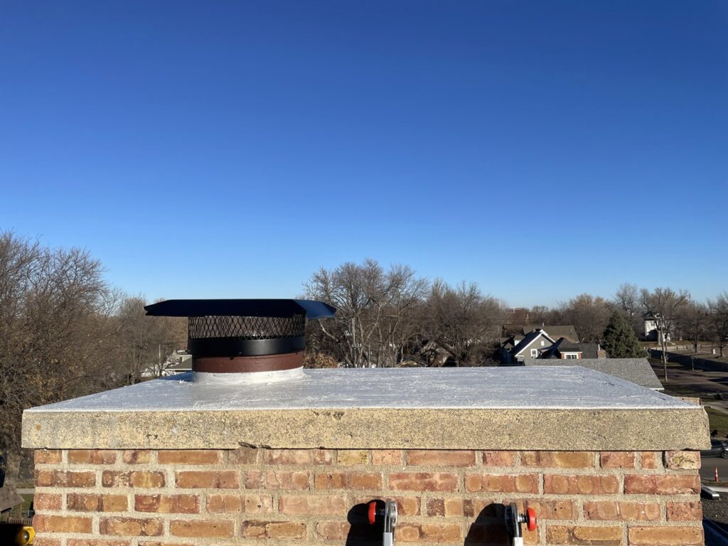 A chimney with a protective cap installed for wildlife exclusion by Prairie Bat Services, LLC in Sioux Falls, SD.