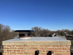 A chimney with a protective cap installed for wildlife exclusion by Prairie Bat Services, LLC in Sioux Falls, SD.