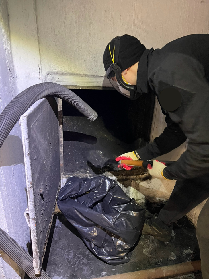 A Chimney Sweep Service LLC technician performing a thorough chimney cleanout in Brooklyn, NY.