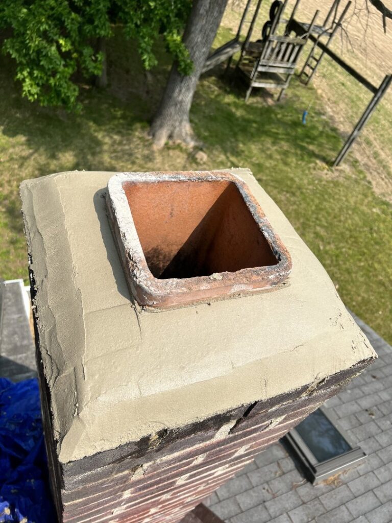 Close-up of a chimney crown with fresh mortar, indicating a recent repair by Maximum Energy Savers in Philadelphia, PA