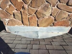 Close-up of new or repaired chimney flashing where the chimney meets the roof, completed by A Step Above Chimney & Siding in Wichita, KS.