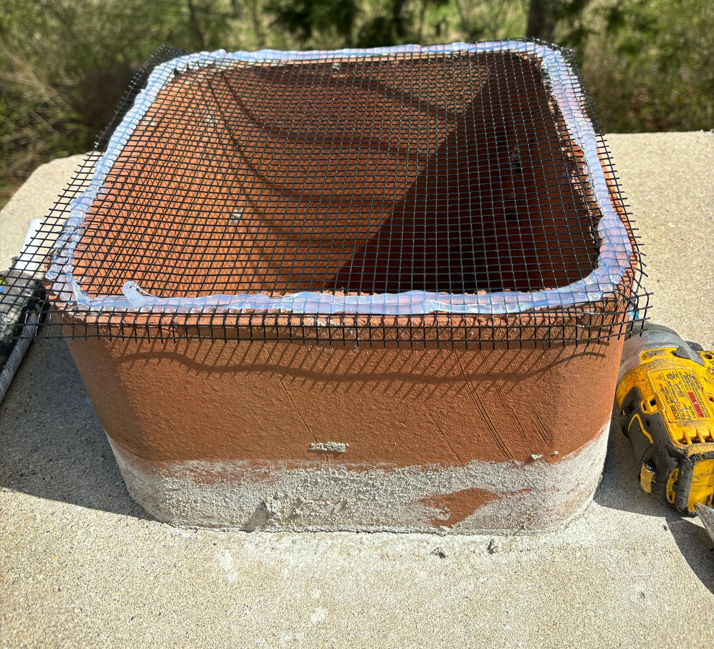 Chimney flue opening being sealed with mesh for wildlife exclusion by Animal Management Systems Inc in Noblesville, IN.