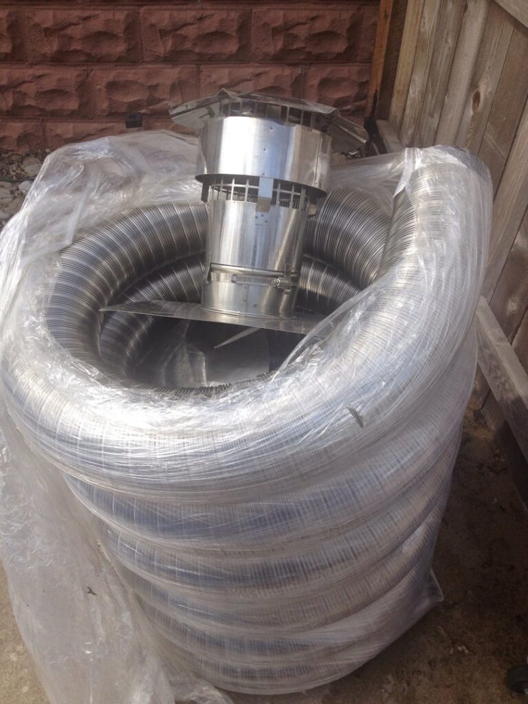 A roll of flexible metal chimney liner with a chimney cap, ready for installation by Chimney Usa Inc in Chicago, IL.