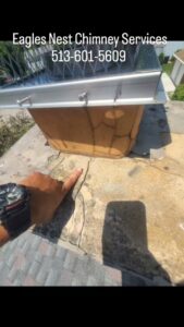 A chimney liner being installed or cleaned from the top of a chimney by Eagles Nest Chimney Services and more of Cincinnati LLC in Cincinnati, OH.