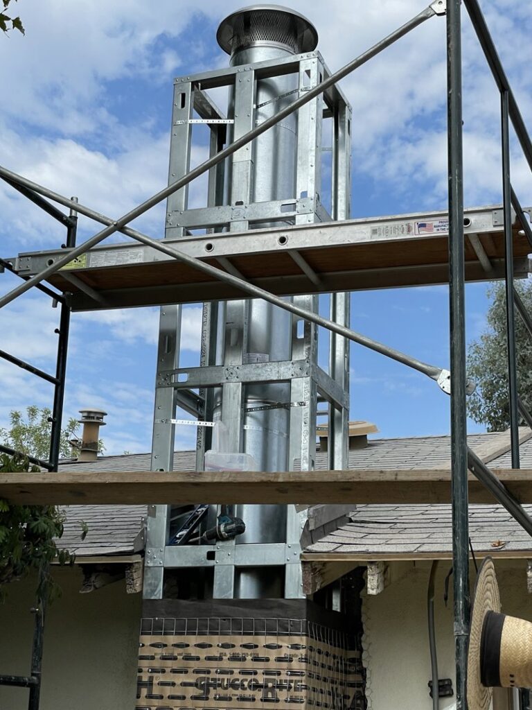 Scaffolding around a chimney during a rebuild or construction project by The Chimney Guy in Los Angeles, CA.