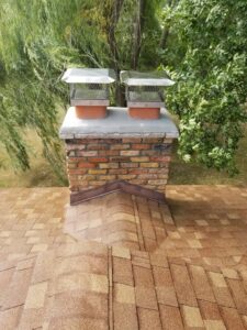 A completed chimney repair with new caps and flashing by JJ Chimney Services in Minneapolis, MN.