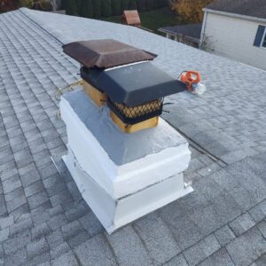 Chimney repair work in progress on a residential roof by Rooftop Chimney Sweeps in Alexandria, VA.