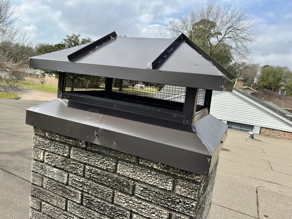 Two Brushers Chimneys workers on a roof, one on a ladder performing chimney repair in Houston, TX.