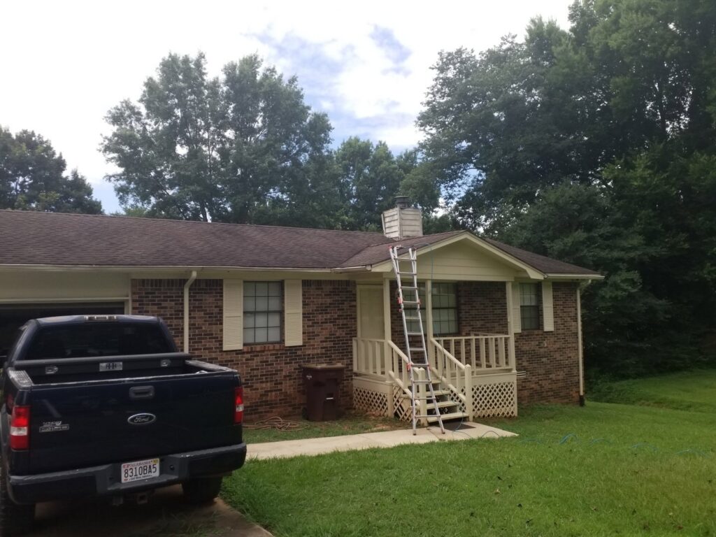 A chimney service job site with a ladder leaning against a house, by Professional Fireplaces and Chimney Sweeps in Huntsville, AL.