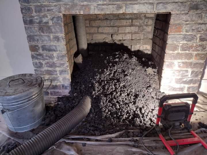 A large pile of soot and creosote removed from a fireplace during a chimney sweep job by A Step Above Chimney & Siding in Wichita, KS.