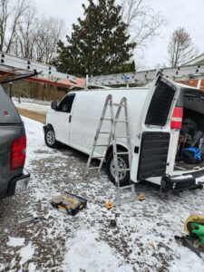 A service van with ladders and tools ready for a chimney sweep job by Professional Fireplaces and Chimney Sweeps in Huntsville, AL.