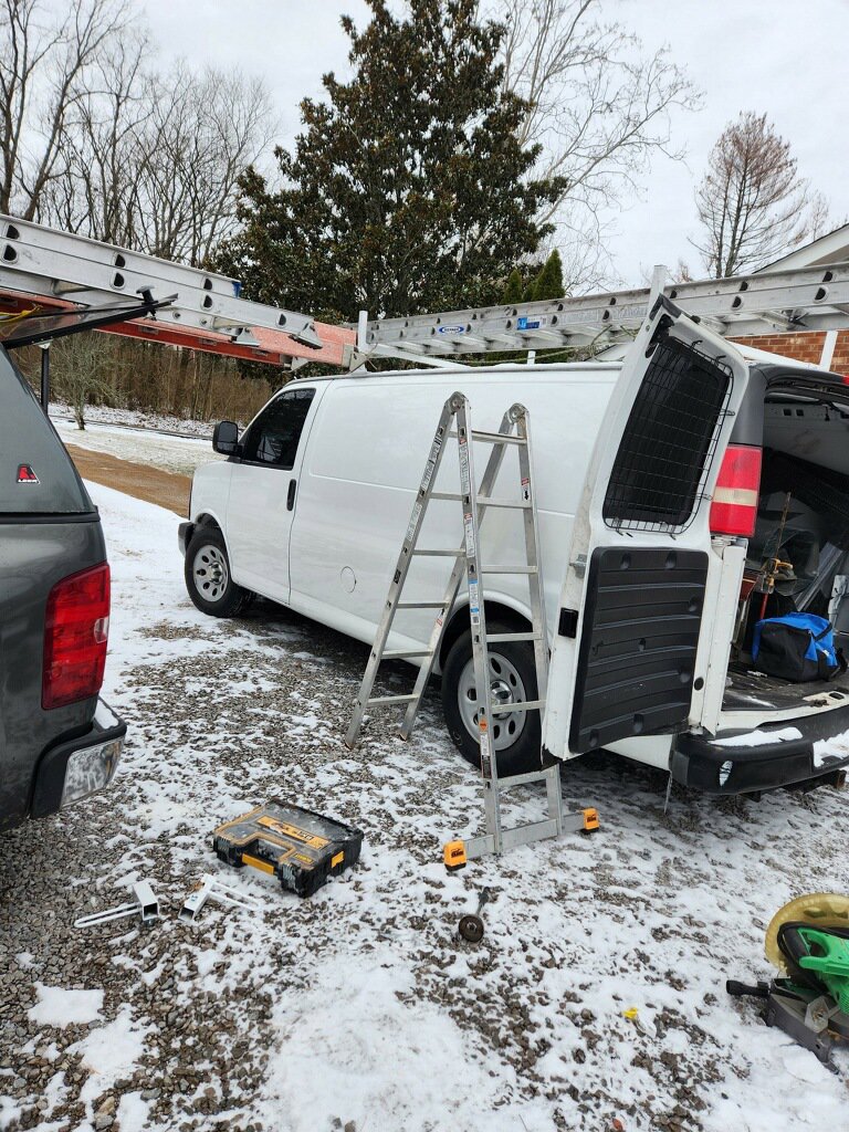 A service van with ladders and tools ready for a chimney sweep job by Professional Fireplaces and Chimney Sweeps in Huntsville, AL.