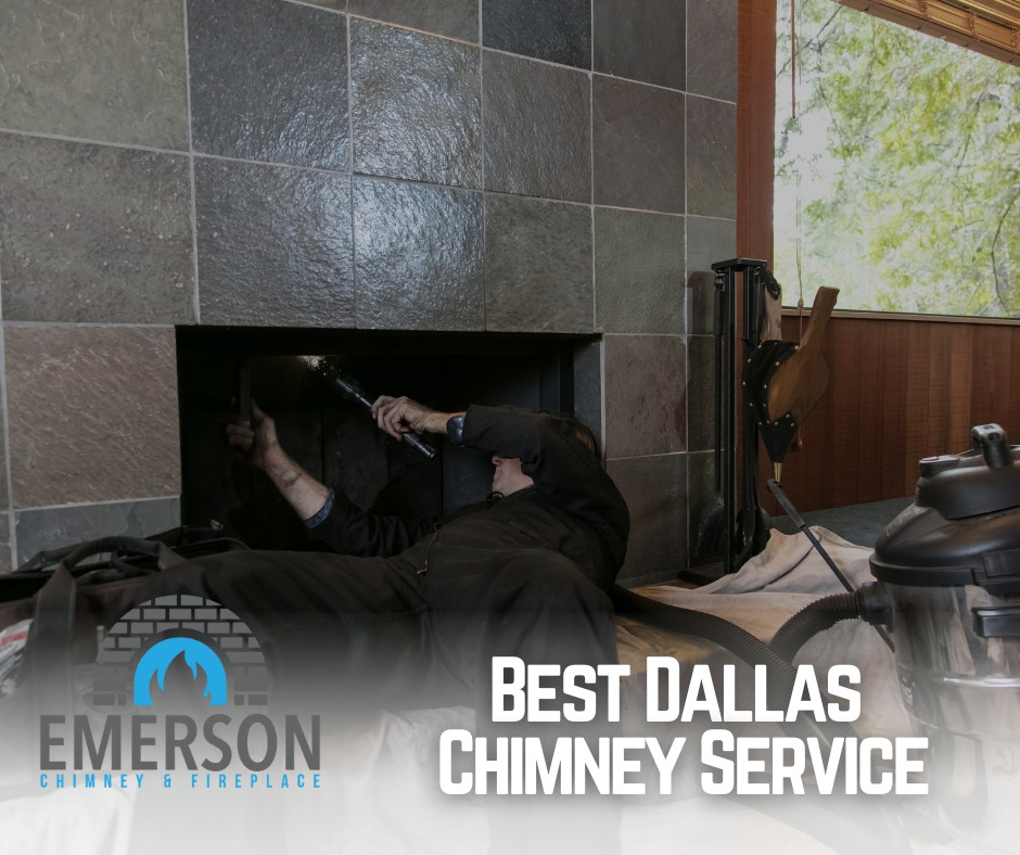 A chimney sweep technician cleaning the inside of a fireplace at Emerson Chimney & Fireplace in Dallas, TX.