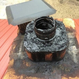 A close-up of a chimney top showing a metal flue liner and creosote buildup, indicating a sweep by A Step Above Chimney & Siding in Wichita, KS.