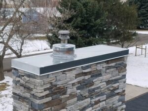 A chimney with a metal vent cap installed by Element Heating & Cooling, Inc. in Twin Falls, ID