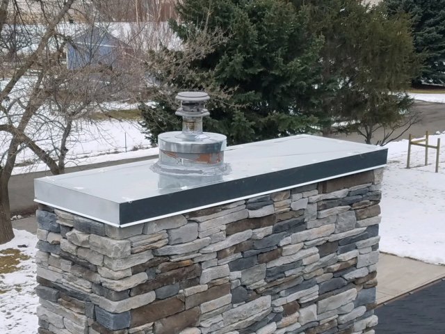 A chimney with a metal vent cap installed by Element Heating & Cooling, Inc. in Twin Falls, ID