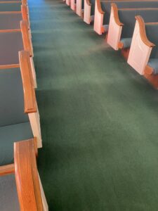 Cleaned green carpet in a church aisle by M3 Cleaning Solutions, LLC in Montgomery, AL.