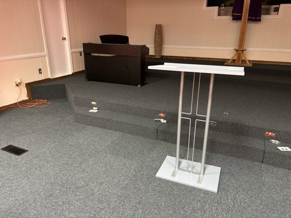 New grey carpet installed on a church stage by Johnson City Flooring & Finish, LLC in Johnson City, TN