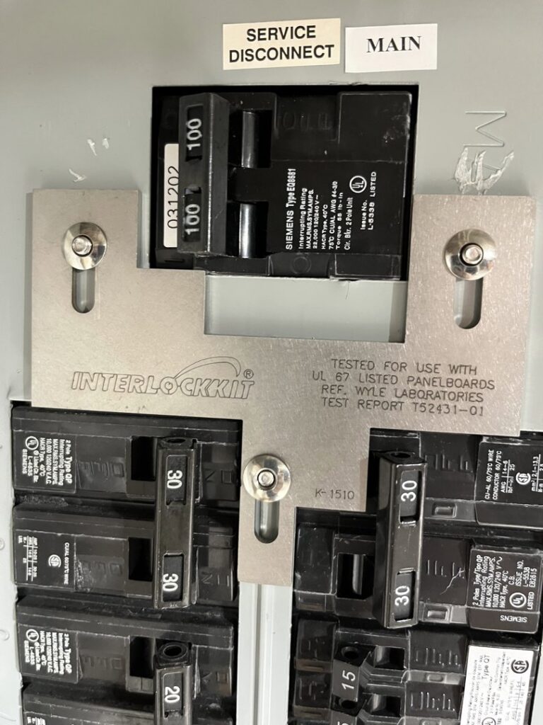 Close-up of a circuit breaker panel with an interlock kit installed by T.S.F Electric in Saco, ME.
