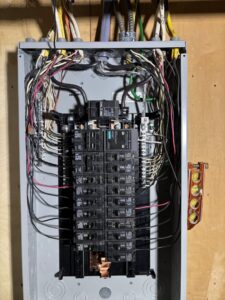 Detailed view of circuit breakers and wiring inside an electrical panel by MV Electrical LLC in Phoenix, AZ.