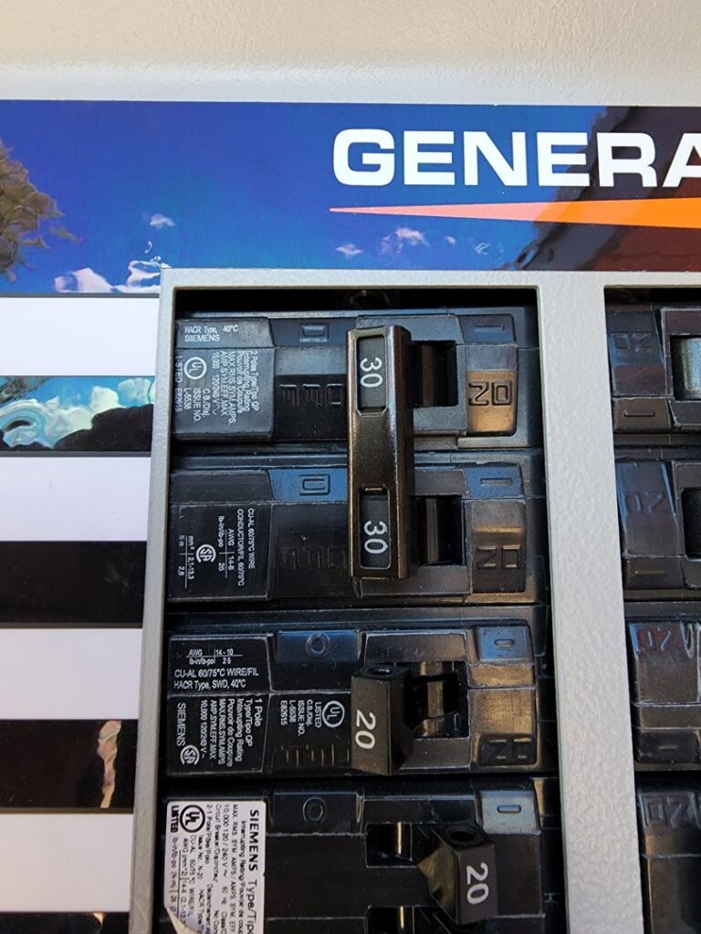 Close-up view of circuit breakers inside an electrical panel, serviced by CDB Electrical LLC in Tucson, AZ.