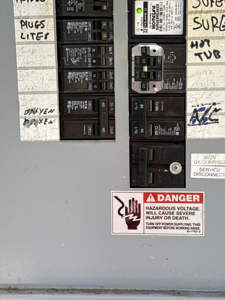 Close-up of circuit breakers in an electrical panel with a danger warning, handled by Esmeralized Electric in San Jose, CA.