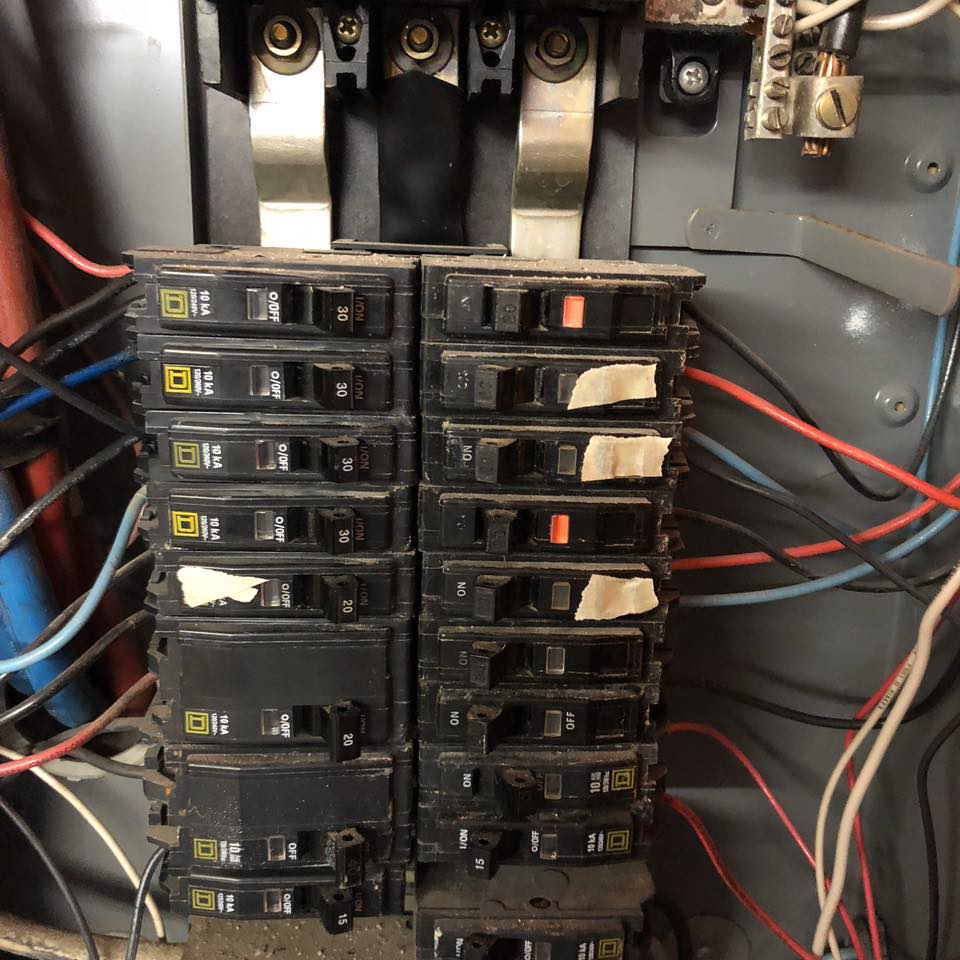 Close-up of circuit breakers and wiring inside an electrical panel, serviced by Gen Pump & Power in Aurora, IL.