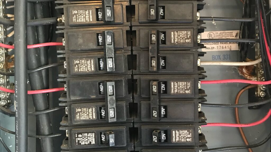 A close-up view of circuit breakers inside an electrical panel, serviced by Phoenix Electric, Inc. in Cape Coral, FL