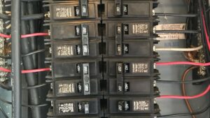 A close-up view of circuit breakers inside an electrical panel, serviced by Phoenix Electric, Inc. in Cape Coral, FL