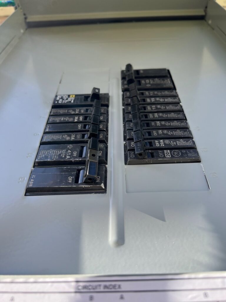 Close-up view of circuit breakers inside an electrical panel, maintained by Solution Electric in Houston, TX.