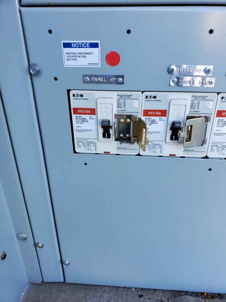 Close-up of circuit breakers and wiring inside an electrical panel, maintained by TJS Electrical Services Inc in Mesa, AZ.