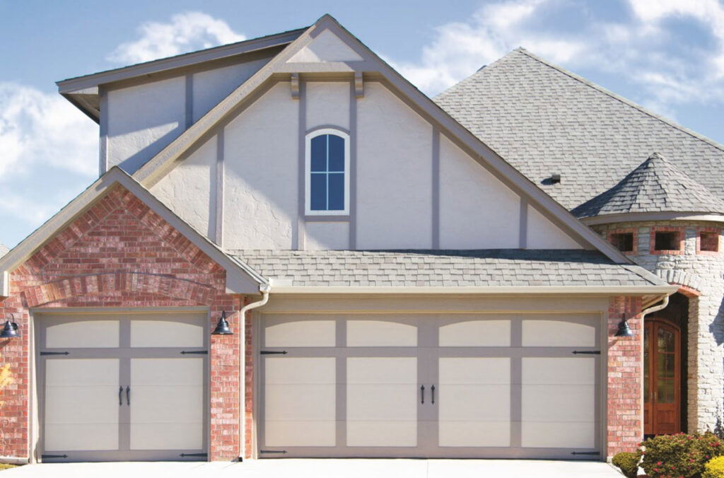 Two classic carriage-style garage doors on a residential home by American Overhead Door in Madison, AL