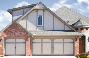 Two classic carriage-style garage doors on a residential home by American Overhead Door in Madison, AL