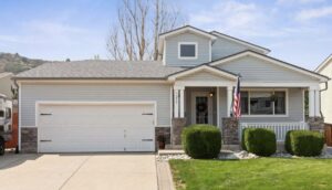 A classic white panel garage door installed on a residential home by Lion Heart Garage Doors in Thornton, CO.