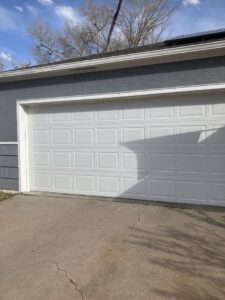 A classic white panel garage door installed on a residential home by Prutch's Garage Door in Colorado Springs, CO.