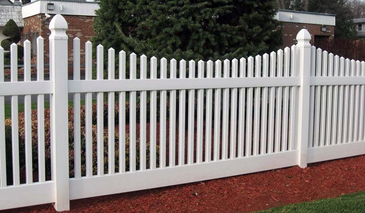 A classic white picket fence installed by Ace Fence Company, enhancing a residential property in Fort Lauderdale, FL.