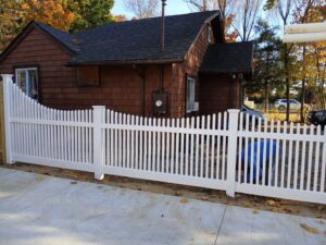 A classic white picket fence enhancing the curb appeal of a front yard, installed by Zelaya Fence in New York City, NY.