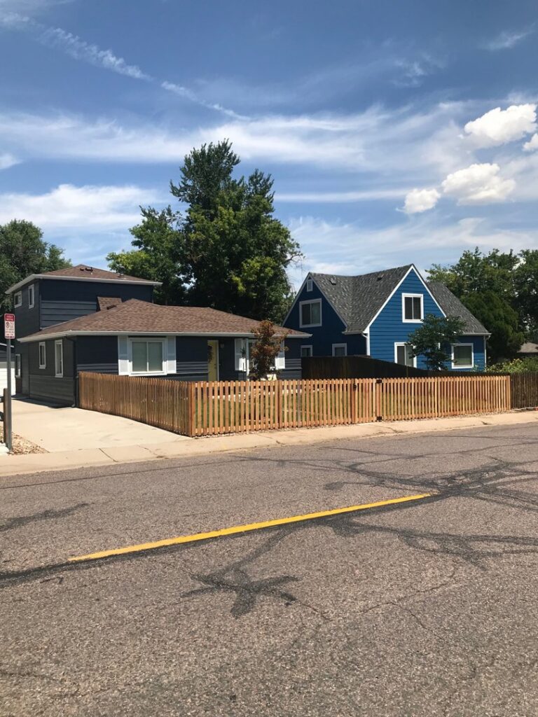 A charming classic wood picket fence installed along a residential street by Fence Guru LLC in Denver, CO.