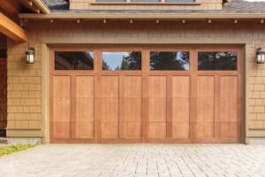 A classic wooden panel garage door with multiple windows, showcasing an installation by 101 Garage Doors in Phoenix, AZ.