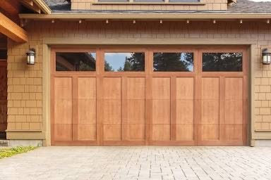 A classic wooden panel garage door with multiple windows, showcasing an installation by 101 Garage Doors in Phoenix, AZ.