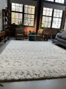 A large, clean area rug in a modern living room after professional cleaning by Get Green Carpet Cleaning CT in West Hartford, CT.